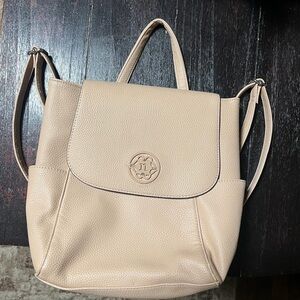 Nanette Lepore pebbled vegan leather backpack in a light pink or beige color.